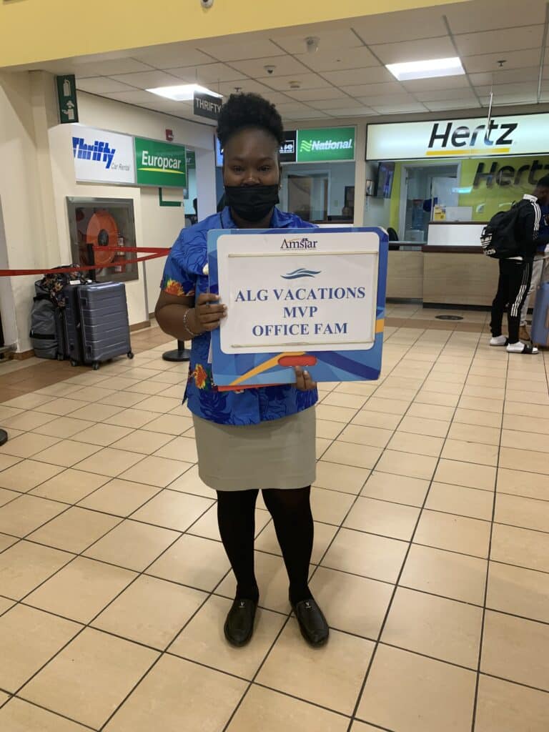 woman holding sign at airport